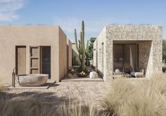 an outdoor bathtub sits in the middle of a desert landscape with cactus and cacti