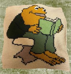 a crocheted pillow with an image of a bird on it's back