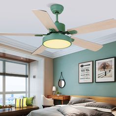 a green ceiling fan in a bedroom next to a bed