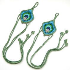 three crocheted necklaces with green string and blue bead designs on them