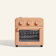 an orange oven with four knobs on the front and two burners on the back