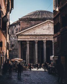 people are walking around in an old city