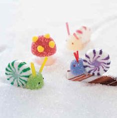 four small toy animals sitting in the snow