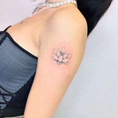 a woman with a small tattoo on her shoulder