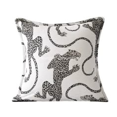 a white and black pillow with leopards on it