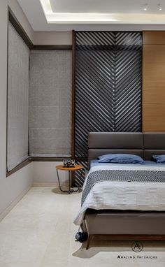 a bedroom with a large bed in the middle of it and a wall behind it