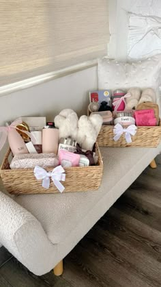 two wicker baskets filled with personal care items on a bench next to a window