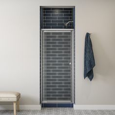 a bathroom with a shower, bench and towel hanging on the wall next to it