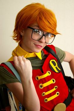 a woman with red hair and glasses wearing a costume