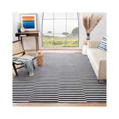 a black and white striped rug in front of a large window with a chair, couch and table