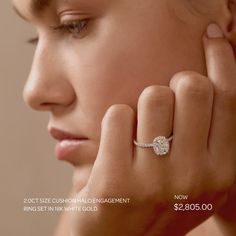 a woman wearing a diamond engagement ring with the price tag $ 2, 600 00