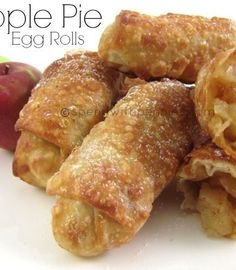 apple pie egg rolls on a white plate with apples in the background and text overlay