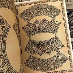 an open book with intricate designs on it