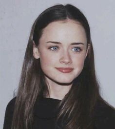 a young woman with long brown hair and blue eyes