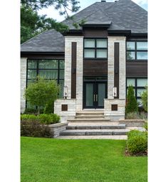 a large house with steps leading up to it's front door and two windows