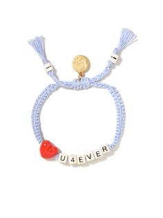 a bracelet with the word u4eiver on it and a heart beaded in gold