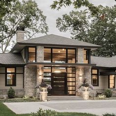 a modern house with stone and glass accents