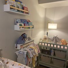 a baby's room with toys and books on the shelves above the crib