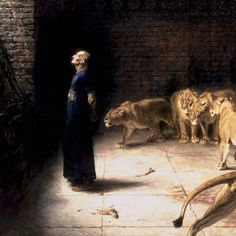 a woman standing next to two lions in a room with other animals on the floor