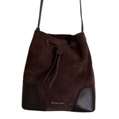 A Michael Kors Bucket Bag From The Cary Collection Crafted In Suede And Smooth Leather And Gold Hardware. This Bucket Bag Features 1 Main Compartment, Drawstring Closure, A Zip Pouch With Pocket, And An Adjustable Strap With A 18"-20.5" Drop. Dimensions: 10.5"W X 11.25"H X 5.75"D. Brand New, Never Been Used. Perfect Condition. Coffee Color, Leather Bucket Bag, Leather Bucket, Coffee Colour, Zip Pouch, Michael Kors Bag, Smooth Leather, Gold Hardware, Bucket Bag