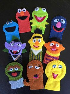 the sesame street puppets are made out of felt and have faces on them, all different colors