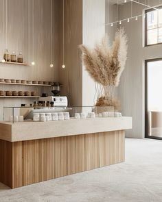 an empty counter in a coffee shop with lots of items on the shelves behind it