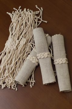 three rolls of jute sitting on top of a wooden table next to each other