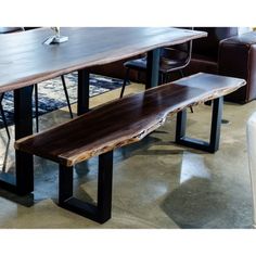 a wooden table and bench in a room