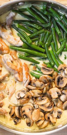 green beans and mushrooms are being cooked in a skillet