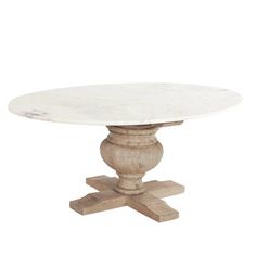 a white marble top dining table with wooden pedestals and two leaves on the base