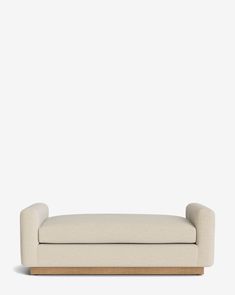 a white couch sitting on top of a wooden frame