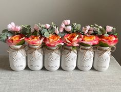 six mason jars with flowers in them are tied to the side and labeled bridal mason