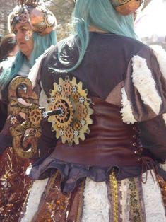 two women dressed in elaborate clothing and headpieces