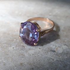 Absolutely lovely vintage created Alexandrite ring with color changing properties. Love how this ring looks deep purple to the prettiest color blue depending on the light. This piece is made with lab curundum, the same material as rubies and sapphires. Currently the ring is a size 7.75 the stone measures approx 18mm long X 15mm wide. The ring is fabricated in 10kt gold and and is very good vintage condition. Vintage Purple Sapphire Gemstone Ring, Purple Sapphire Vintage Ring For Anniversary, Vintage Purple Sapphire Ring For Anniversary, Vintage Purple Sapphire Anniversary Ring, Vintage Purple Solitaire Ring, Vintage Purple Sapphire Ring For Gift, Vintage Purple Sapphire Ring As Gift, Vintage Purple Sapphire Ring Gift, Vintage Oval Solitaire Amethyst Ring