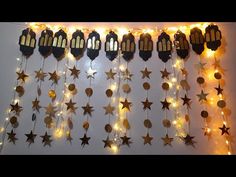 some lights are hanging on the wall and stars have been hung from them to decorate