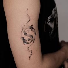 a woman's arm with a tattoo design on the left side of her arm