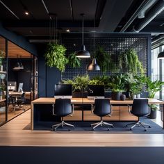 an office with plants on the wall and desks in front of it, along with chairs