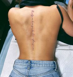 the back of a woman's lower back tattoo that reads, i love you