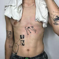 a man with many tattoos on his chest