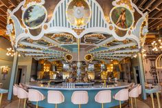 an ornately decorated carousel bar with pink chairs