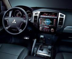 the interior of a car with dashboard, steering wheel and dash board in black leather