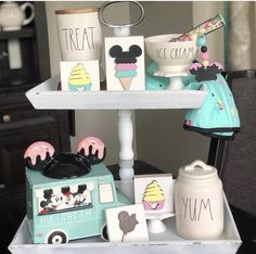 a tray that has some ice cream and cupcakes on it with mickey mouse figurines