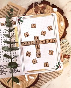 a crossword game is displayed on top of an open book with greenery in the foreground