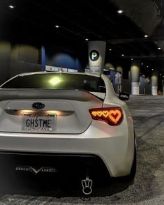 the back end of a white sports car