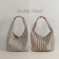 two bags sitting next to each other on top of a white surface with the words double sided