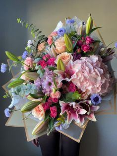 a large bouquet of flowers sitting on top of a table