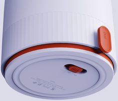 an orange and white electronic device is attached to the side of a wall or ceiling