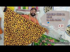 a man is holding up a leopard print blanket