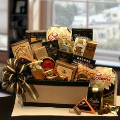 a gift basket filled with chocolates, candies and other items on a table