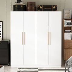 a white cabinet sitting in the middle of a living room next to a black and white rug